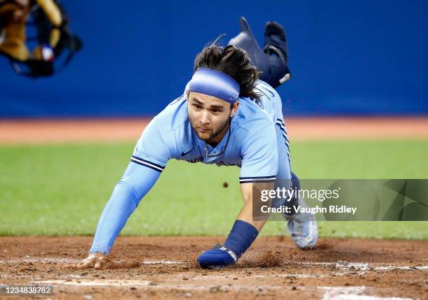 Bo Bichette of the Toronto Blue Jays scores a run on a double by Vladimir Guerrero Jr. #27 in the sixth inning during a MLB game against the Chicago...