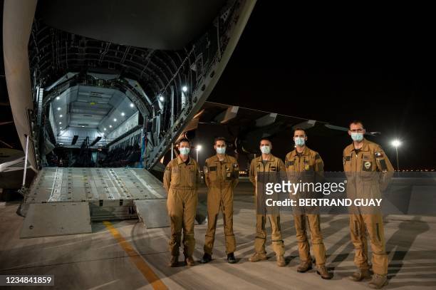 The crew of an A400M military transport aircraft poses after evacuating people from Kabul as part of the operation "Apagan" at the French military...