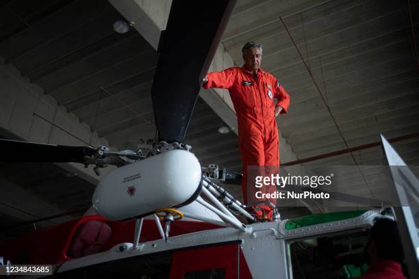 Firefight engineers inspect an AB412 helicopter before flight in Lamezia Terme , Italy, on August 23, 2021. The flight department of the fire brigade...