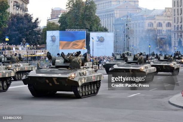 Ukrainian military vehicles drive in formation in a rehearsal of military parade in preparation for the upcoming Independence Day on August 24 at...