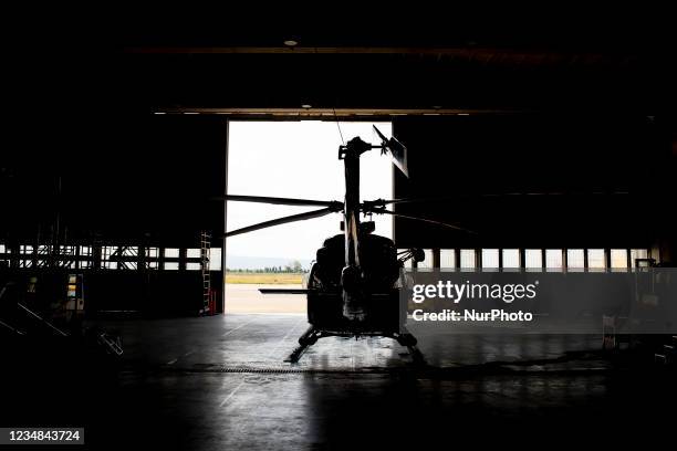 Silhouette of an AB421 helicopter inside the hangar in Lamezia Terme , Italy, on August 23, 2021. The flight department of the fire brigade of the...