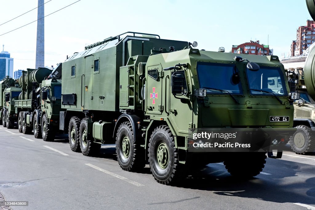 Ukrainian military vehicles drive in formation during the...
