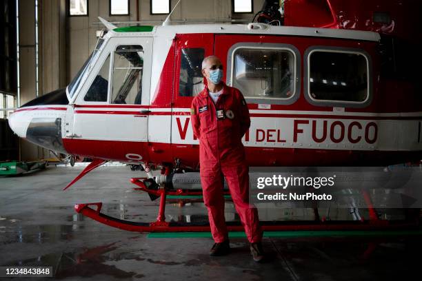 The local foreman of the flight department of the fire brigade, in front of the helicopter AB412 used for the rescues, in Lamezia Terme , Italy, on...