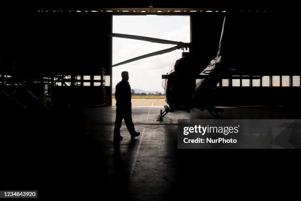 Silhouette of a firefighter during the pre-flight steps in Lamezia Terme , Italy, on August 23, 2021. The flight department of the fire brigade of...