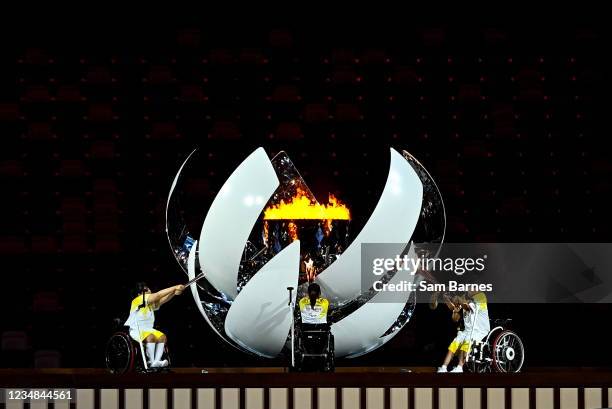 Tokyo , Japan - 24 August 2021; The Paralympic flame is lit by, from left, Shunsuke Uchida, Yui Kamiji and Karin Morisaki during the Opening Ceremony...