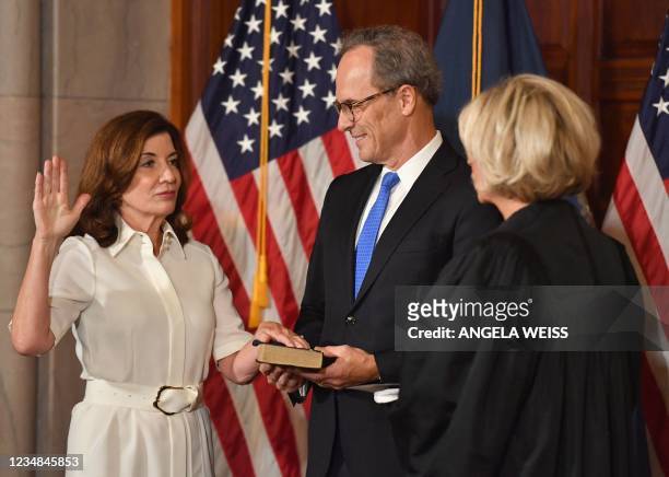 New York Governor Kathy Hochul with her husband William J. Hochul Jr. Is sworn in by Chief Judge Janet DiFiore during a ceremony at the New York...