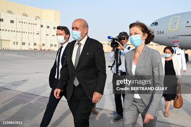 French Foreign Minister Jean-Yves Le Drian and French Defence Minister Florence Parly get off a plane at the French military air base 104 of Al...