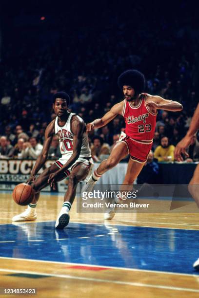 Mickey Davis of the Milwaukee Bucks handles the ball against Rowland Garrett of the Chicago Bulls during a game circa 1971 at the MECCA Arena in...