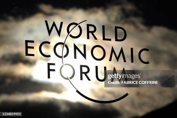 The sky reflects on the logo of the World Economic Forum on the congress center on January 25, 2011 on the eve annual WEF meeting in Davos....