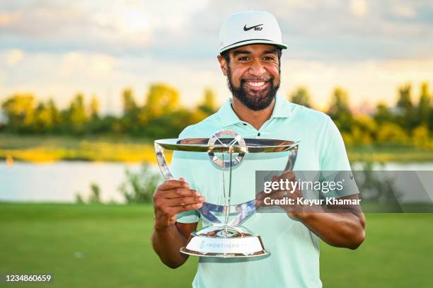 Tony Finau smiles with the tournament trophy following his playoff victory during the final round of THE NORTHERN TRUST, the first event of the...