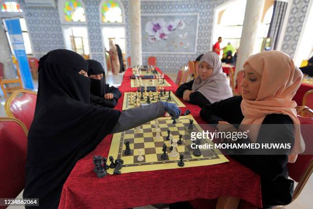 Women take part in a local Chess championship in Yemen's capital Sanaa on August 25, 2021.