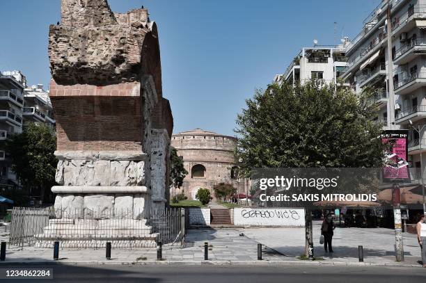 People walk near the Arch of Galerius and the Rotunda in the city of Thessaloniki on August 25, 2021. Built between 298 and 305 AD to commemorate...