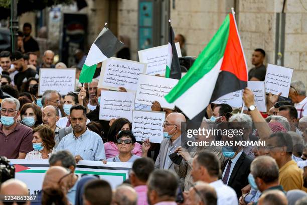 Protesters rally in the city of Ramallah in the occupied West Bank on August 25, 2021 for a demonstration denouncing the Palestinian Authority in the...