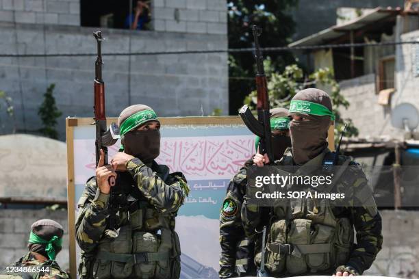 Members of the Al-Qassam Brigades of Hamas participate in a military parade in Osama Deeij's funeral. Osama Deeij died of a wound he sustained during...