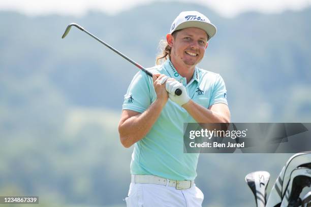 Cameron Smith of Australia smiles while practicing on the range prior to the BMW Championship at Caves Valley Golf Club on August 24, 2021 in Owings...