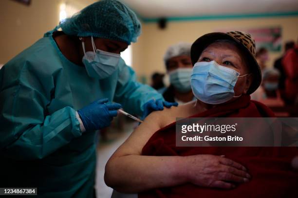 Health worker applies a dose of Janssen vaccine as part of the vaccination campaign against COVID-19 at Rodriguez wholesale market on August 25, 2021...