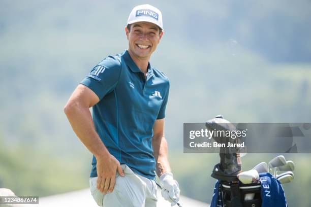 Viktor Hovland of Norway smiles while practicing on the range prior to the BMW Championship at Caves Valley Golf Club on August 24, 2021 in Owings...