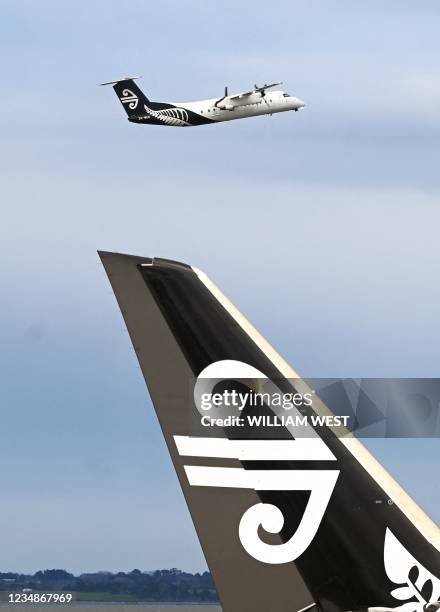 Photo taken on August 9, 2021 shows an Air New Zealand plane taking off from Auckland Airport with the national carrier managing to cut its losses by...