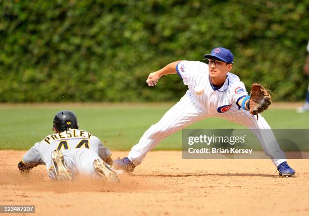 Alex Presley of the Pittsburgh Pirates steals second base as second baseman Darwin Barney of the Chicago Cubs catches the throw from catcher Geovany...