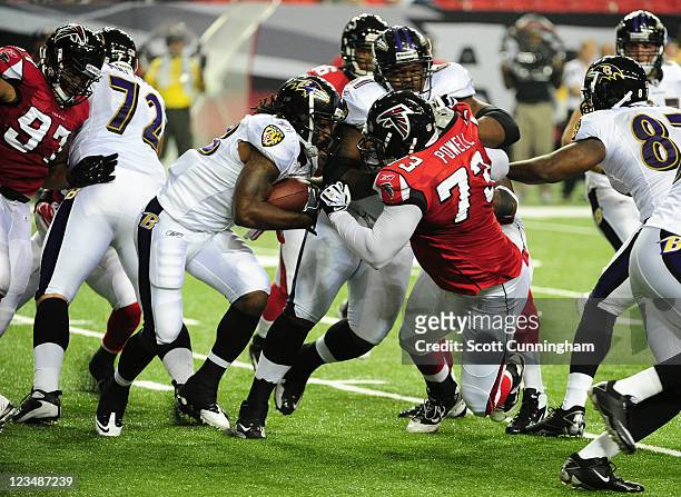 Damien Berry of the Baltimore Ravens carries the ball against Carlton Powell of the Atlanta Falcons during a preseason game at the Georgia Dome on...