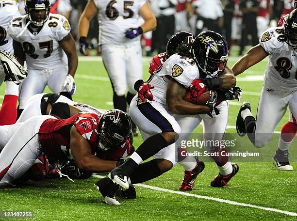 Damien Berry of the Baltimore Ravens carries the ball against the Atlanta Falcons during a preseason game at the Georgia Dome on September 1, 2011 in...