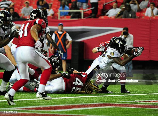 Damien Berry of the Baltimore Ravens scores a touchdown against the Atlanta Falcons during a preseason game at the Georgia Dome on September 1, 2011...