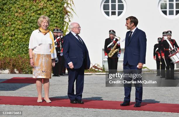 French President Emmanuel Macron is greeted by Irish President Michael D. Higgins and his wife Sabina Coyne as he arrives at Áras an Uachtaráin on...