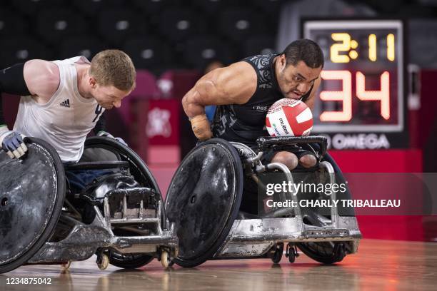 Britain's Gavin Walker vies for the ball with New Zealand's Barney Koneferenisi during the group B wheelchair rugby match between Britain and New...