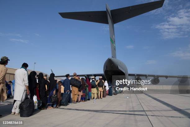 In this handout provided by U.S. Central Command Public Affairs, U.S. Air Force loadmasters and pilots assigned to the 816th Expeditionary Airlift...