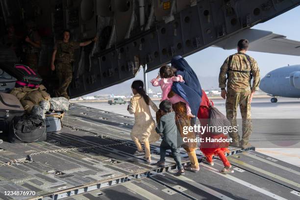 In this handout provided by U.S. Central Command Public Affairs, U.S. Air Force loadmasters and pilots assigned to the 816th Expeditionary Airlift...