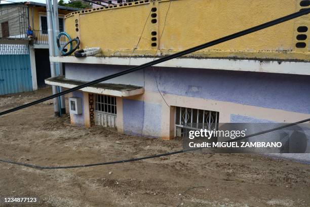 View of some houses covered with mud after a landslide caused by heavy rains in the community of El Corozo, one of the most affected in the...