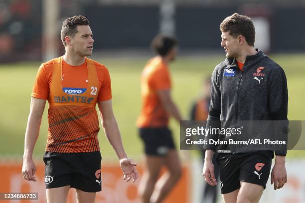 Josh Kelly of the Giants and Jacob Hopper of the Giants are seen during the GWS Giants training session at North Port Oval on August 27, 2021 in...