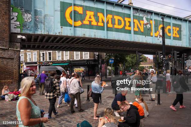 Visitors in the Camden Lock area of Camden, London, U.K., on Thursday, Aug. 19, 2021. The pandemic has pulled the fortunes of British consumers in...