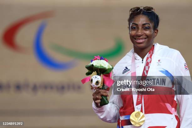 Kadeena Cox of Team Great Britain celebrates on the podium after winning gold during the medal ceremony for the Track Cycling Women's C4-5 500m Time...