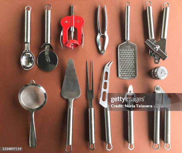 home inventory: knolling of kitchen tools on brown background - can opener stock pictures, royalty-free photos & images