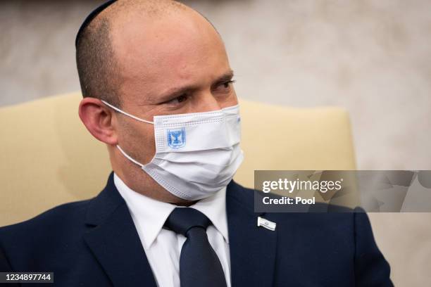 Israeli Prime Minister Naftali Bennett listens during a meeting with U.S. President Joe Biden in the Oval Office at the White House on August 27,...