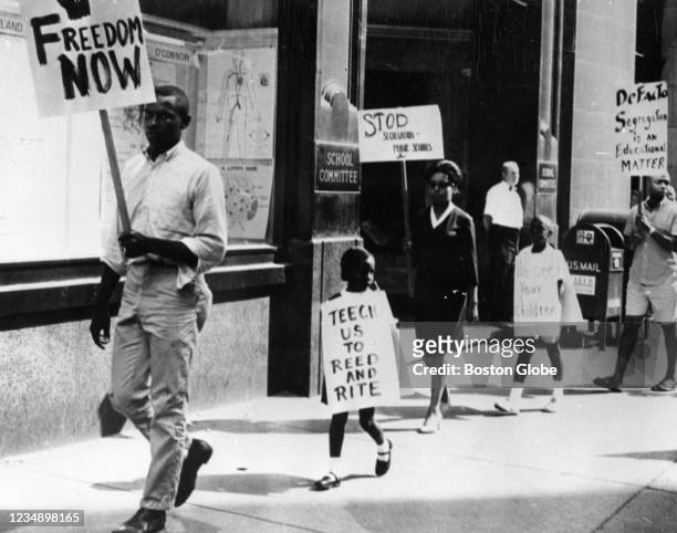 Boston, MA Black protesters picketing against Boston school segregation in Boston, August 07, 1963. The protesters are holding signs that read:...