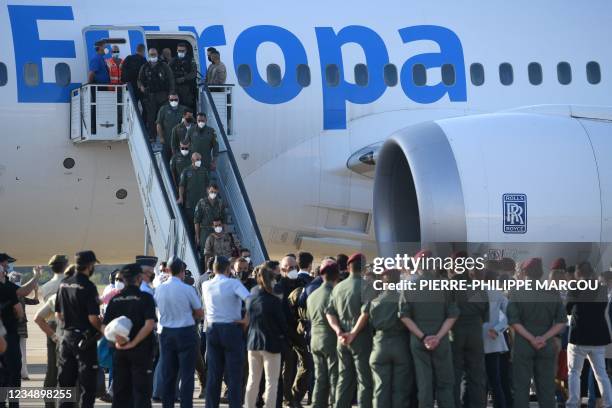 Members of Spanish National Police forces and military personnel who were stationed in Afghanistan disembark from the last Spanish evacuation flight,...