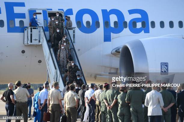 Members of Spanish National Police forces and military personnel who were stationed in Afghanistan disembark from the last Spanish evacuation flight,...