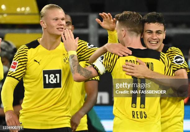 Dortmund's US midfielder Giovanni Reyna celebrates scoring the opening goal with his teammates Dortmund's German forward Marco Reus and Dortmund's...