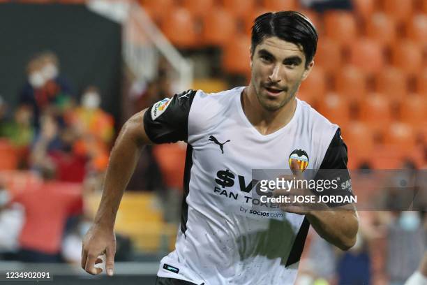 Valencia's Spanish midfielder Carlos Soler celebrates scoring his team's second goal during the Spanish League football match between Valencia and...