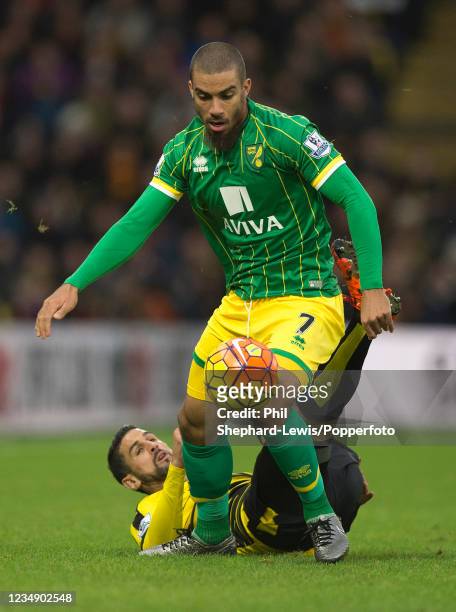 Lewis Grabban of Norwich City evades the challenge from Miguel Britos of Watford during a Barclays Premier League match at Vicarage Road on December...