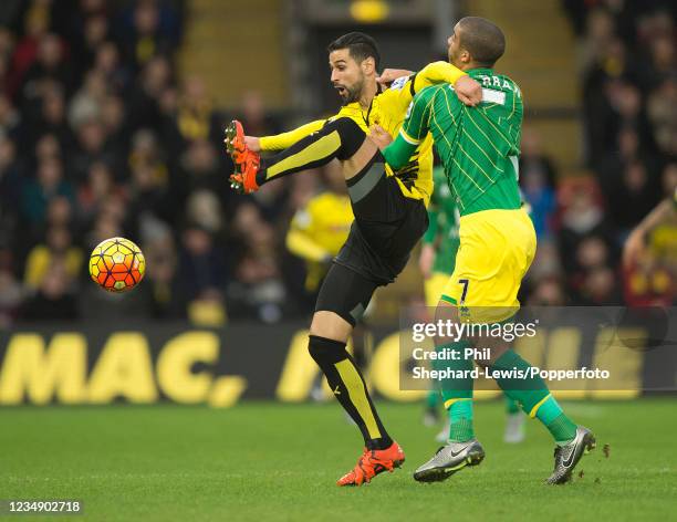 Miguel Britos of Watford holds off the challenge from Lewis Grabban of Norwich City during a Barclays Premier League match at Vicarage Road on...