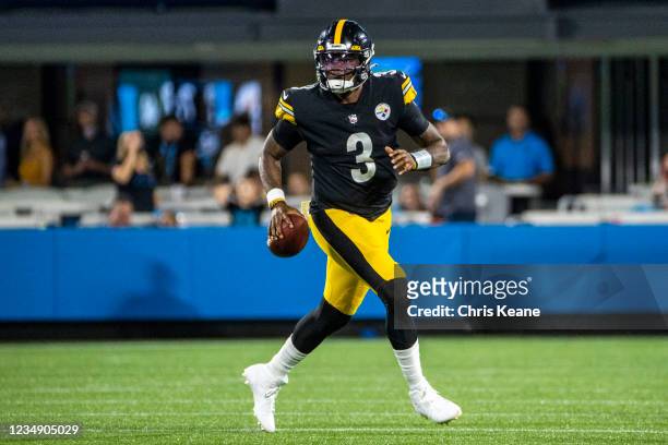 Dwayne Haskins of the Pittsburgh Steelers rolls out of the pocket against the Carolina Panthers during the first half of an NFL preseason game at...