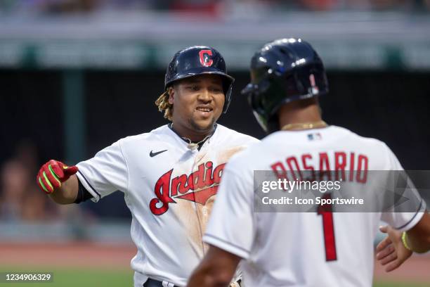 Cleveland Indians third baseman Jose Ramirez is congratulated by Cleveland Indians infielder Amed Rosario after after hitting a 2-run home run during...