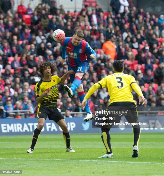 Connor Wickham of Crystal Palace scores a headed goal as Nathan Ake and Miguel Britos of Watford look on during the FA Cup Semi Final at Wembley...