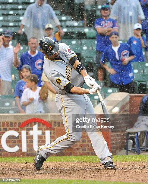 Derrick Lee of the Pittsburgh Pirates connects on a grand slam scoring teammates Xavier Paul, Jose Tabata and Andrew McCutchen during the ninth...