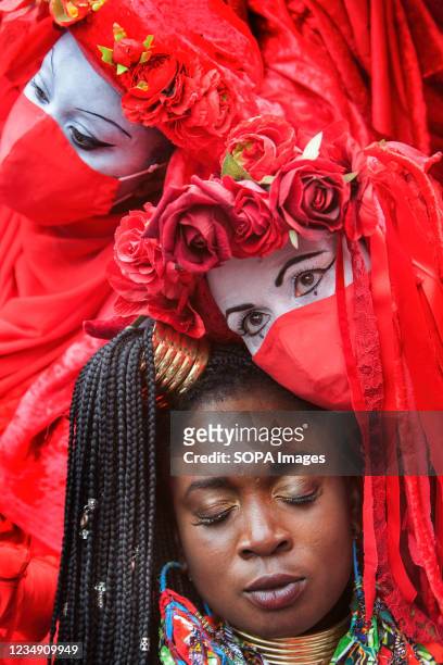 Red Rebel Brigade joins fellow protester Marvina Newton as part of the Impossible Rebellion, during the March. They believe that the city of London...