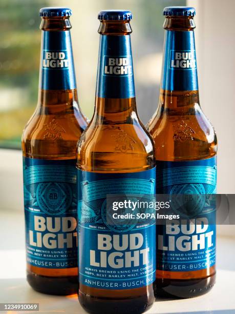 In this photo illustration, the Bud Light beer bottles seen displayed in a store. This beer is produced by Anheuser-Busch, ink.