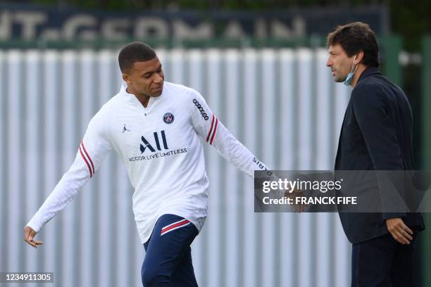 Paris Saint-Germain's Brazilian sporting director Leonardo speaks with Paris Saint-Germain's French forward Kylian Mbappe prior to a training session...